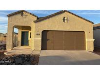 Single-Gathering home with a two-car garage, neutral stucco, a dark teal front door, and a concrete driveway at 5152 E Umber Rd, San Tan Valley, AZ 85143