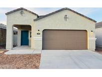 Charming single-story home featuring a two-car garage, stylish blue front door, and low-maintenance desert landscaping at 5152 E Umber Rd, San Tan Valley, AZ 85143