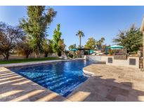Luxury pool with waterfall and ample lounge space at 5817 E Leith Ln, Scottsdale, AZ 85254