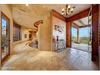 Grand entryway with tile floors, curved walls, and views to backyard at 6520 E El Sendero Rd, Carefree, AZ 85377