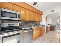 Modern kitchen with granite counters, stainless steel appliances, and wood cabinets at 8241 N Central Ave # 11, Phoenix, AZ 85020