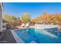 Inviting backyard oasis featuring a sparkling pool, a water feature and comfortable lounge chairs at 918 W Yellowstone Way, Chandler, AZ 85248