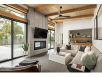 Open living space with fireplace, pool view, and comfortable seating at 1442 E Rancho Dr, Phoenix, AZ 85014