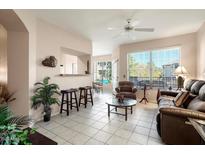 Bright living room with recessed lighting, tile floors, and comfy seating at 14950 W Mountain View Blvd # 3209, Surprise, AZ 85374