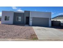 New modern home with two-tone exterior and two-car garage at 15200 S Diablo Rd, Arizona City, AZ 85123