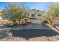 Two-story house with a two-car garage and desert landscaping at 2403 W Via Dona Rd, Phoenix, AZ 85085
