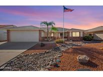 Charming home featuring a low maintenance yard with decorative rock landscaping and an American flag at 2466 S Acanthus --, Mesa, AZ 85209