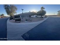 Landscaped front yard with desert landscaping and a long driveway at 3953 W Mustang Ct, Eloy, AZ 85131