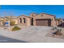 One-story house with a two-car garage and desert landscaping at 40950 W Bedford Dr, Maricopa, AZ 85138