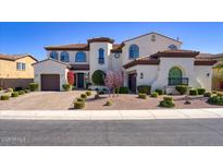 Stunning two-story home featuring a well-manicured yard, elegant architecture, and a welcoming entrance at 5528 E Windstone Trl, Cave Creek, AZ 85331