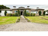 Stunning two-story home with stone accents and a beautifully landscaped front yard at 5827 S Marin Ct, Gilbert, AZ 85298