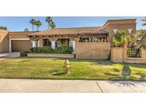 Spanish style home with tile roof, lush landscaping, and a grassy front yard at 8082 E Via Del Desierto --, Scottsdale, AZ 85258
