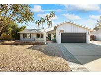 Updated single story home with a two-car garage and nicely landscaped front yard at 10723 E Mescal St, Scottsdale, AZ 85259