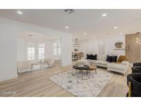 Spacious living room with light wood floors and comfortable seating at 126 E Northern Ave, Phoenix, AZ 85020
