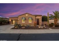 Beautiful desert home exterior at sunset; stone accents and landscaped yard at 13036 W Fetlock Trl, Peoria, AZ 85383