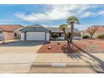 Single-story home with attached garage and desert landscaping at 14413 W Sky Hawk Dr, Sun City West, AZ 85375