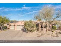Charming single-story home featuring a three-car garage, desert landscaping, and a welcoming entrance at 18932 N Aztec Point Dr, Surprise, AZ 85387