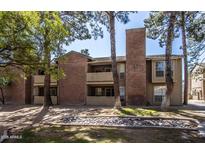 Brick condo building with landscaping and trees at 200 E Southern Ave # 242, Tempe, AZ 85282