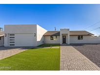 Modern single-story home with a two-car garage and landscaped lawn at 2129 S Los Feliz Dr, Tempe, AZ 85282