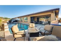 Expansive backyard with a refreshing pool, comfortable seating, and fire pit at 2238 E Saddlebrook Rd, Gilbert, AZ 85298