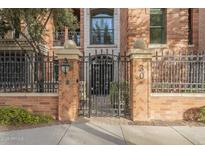 Brick building with ornate iron gate and landscaping at 30 W Palm Ln, Phoenix, AZ 85003