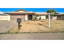 Single story home with attached garage and front yard at 4618 W Montebello Ave, Glendale, AZ 85301