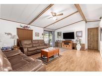 Living room with two leather sofas, coffee table, and wood floors at 9333 E University Dr # 147, Mesa, AZ 85207