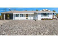 White single story home with carport and gravel driveway at 12001 N Pebble Beach Dr, Sun City, AZ 85351