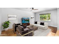 Bright living room featuring a neutral color palette and large window at 1643 W Harmont Dr, Phoenix, AZ 85021