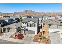 Aerial view of two-story house with gray exterior, landscaping, and mountain backdrop at 20838 W Granada Rd, Buckeye, AZ 85396