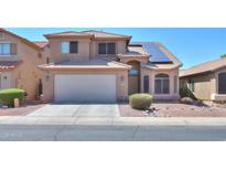 Two-story house with solar panels and desert landscaping at 21404 N Van Loo Dr, Maricopa, AZ 85138