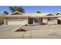 Single-story home with two-car garage and desert landscaping at 2544 S Daisy --, Mesa, AZ 85209