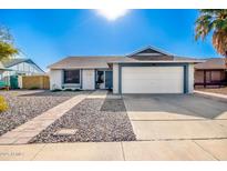 Single-story home with a two-car garage and a well-maintained front yard at 3235 W Irma Ln, Phoenix, AZ 85027