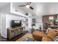 Open living area with leather sectional sofa, wood floors, and stylish decor at 3302 N 7Th St # 208, Phoenix, AZ 85014