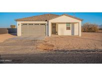 New single-story home with gray garage door and neutral exterior at 3515 N Tewa Cir, Eloy, AZ 85131