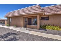 Tan stucco condo building with a tile roof and walkway at 409 W Pontiac Dr # 8, Phoenix, AZ 85027