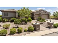 Single-story home with landscaped front yard, two-car garage, and desert landscaping at 11175 N 121St Way, Scottsdale, AZ 85259