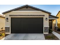 New construction home with two-car garage and neutral color scheme at 14627 W Valentine St, Surprise, AZ 85379
