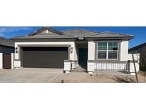 New single-story home with a two-car garage and desert landscaping at 25380 W Sunland Ave, Buckeye, AZ 85326