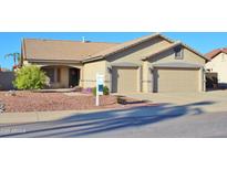 Tan two-story house with a three-car garage and landscaped front yard at 4550 E Olney Ave, Gilbert, AZ 85234