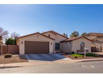 Single-story home with a two-car garage and landscaped front yard at 735 W Basswood Ave, San Tan Valley, AZ 85140