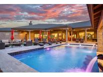 Luxury pool and spa with spacious patio and seating area at 9968 W Jj Ranch Rd, Peoria, AZ 85383