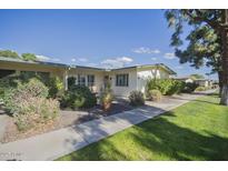Attractive exterior of a single-story home with well-maintained landscaping and walkway at 10533 W Wheatridge Dr, Sun City, AZ 85373