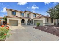 Two-story house with three-car garage and desert landscaping at 13616 W San Miguel Ave, Litchfield Park, AZ 85340