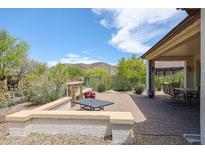 Backyard patio with fire pit and seating area at 17510 W Glenhaven Dr, Goodyear, AZ 85338