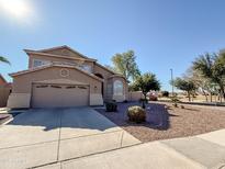 Two-story house with attached garage and desert landscaping at 321 W Betsy Ln, Gilbert, AZ 85233