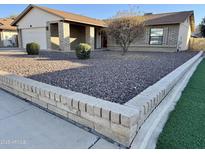 Ranch style home with landscaped yard and two-car garage at 5415 W Desert Hills Dr, Glendale, AZ 85304