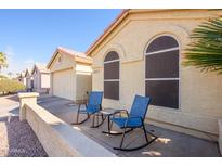 View of the front of the house with two rocking chairs on the patio at 6877 S Oakmont Dr, Chandler, AZ 85249