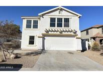 Two-story house with white garage door and landscaping at 13620 W San Juan Ave, Litchfield Park, AZ 85340