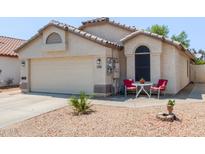 Charming single-story home with a two-car garage and well-maintained landscaping at 15306 W Eureka Trl, Surprise, AZ 85374